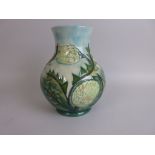 A Moorcroft Banksia design baluster Vase with tube lined flowers and foliage, 10in H