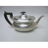 An Edward VII silver Teapot of boat shape with gadroon embossing engraved crest, London 1909