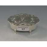 An Edward VII silver oval Trinket Box, the lid embossed cat and shaped surround, Sheffield 1907