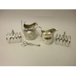 Four various silver Cream Jugs, two embossed and two plain and a Georgian Sauce Boat, repaired