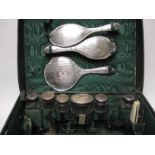 A George V Vanity Case with silver mounted fittings including jars, brushes, mirror, buffer, etc,