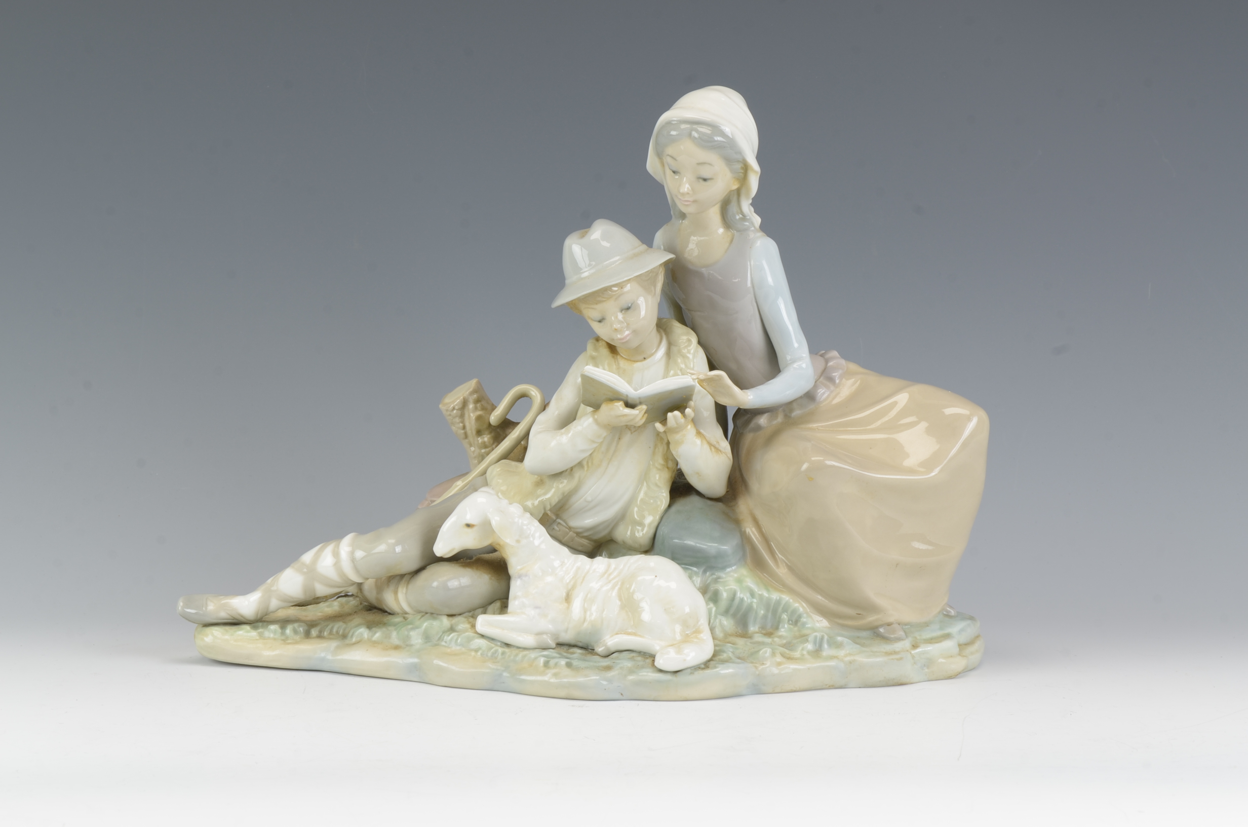 A Lladro Figure of Shepherd and Shepherdess with Lamb, 12in