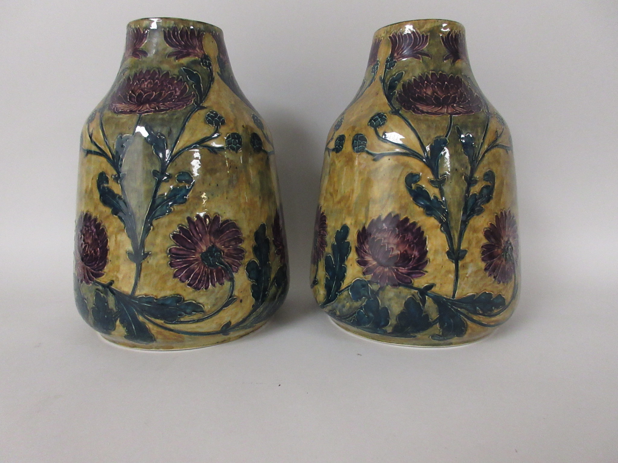 A pair of Hancock & Sons Morrisware Vases by George Cartlidge decorated purple chrysanthemums on a