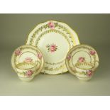 A pair of 19th Century porcelain Teacups and Saucers, and a matching dinner plate, probably