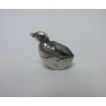 An Edward VII silver Pin Cushion in the form of a chick emerging from an egg, Birmingham 1908