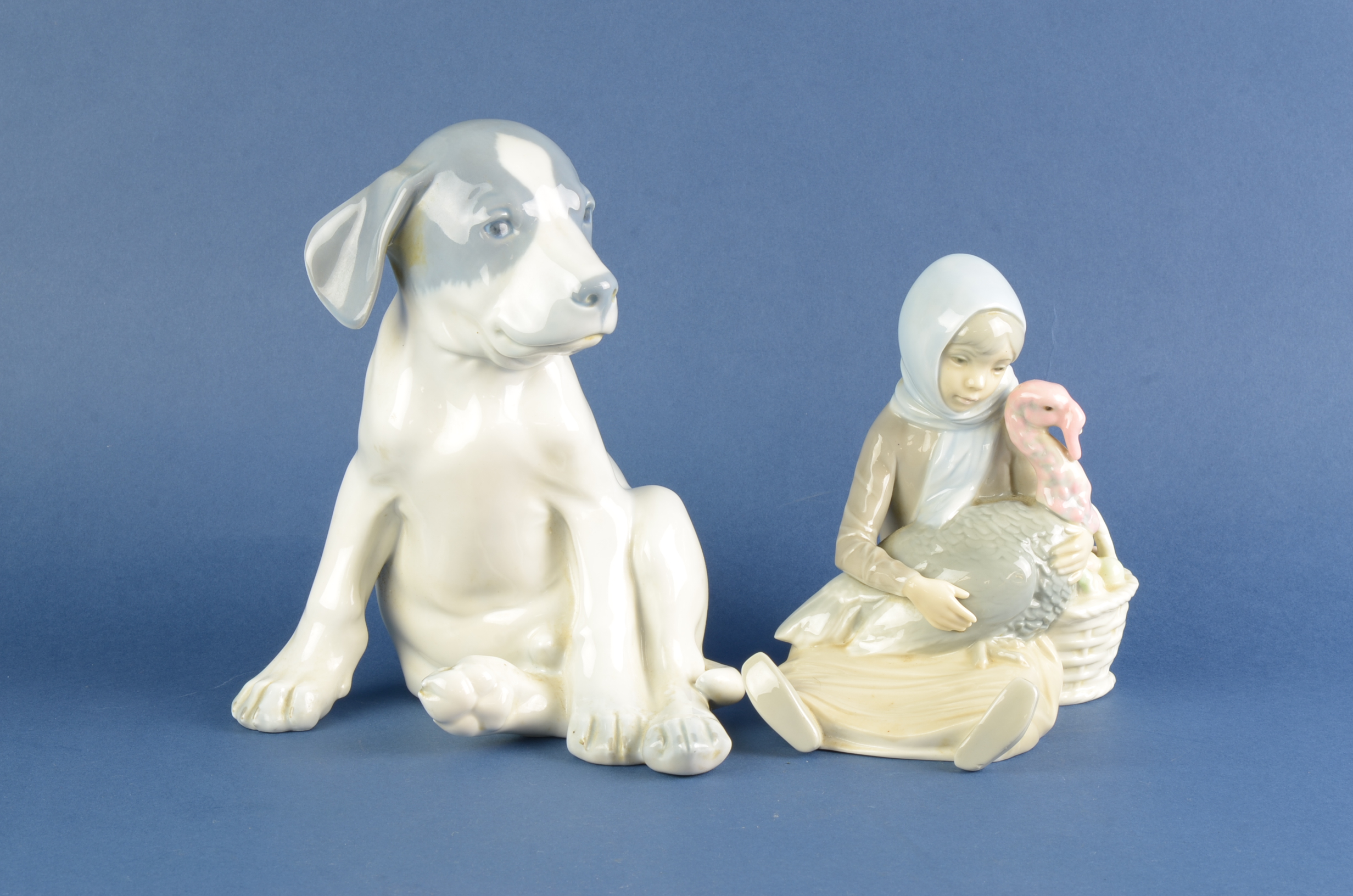 A Lladro Figure of a girl with turkey, 6in and a Copenhagn Figure of seated puppy, 8in