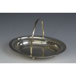 A George V silver pierced oval Cake Basket with engraved cartouche, swing handle, Birmingham 1921