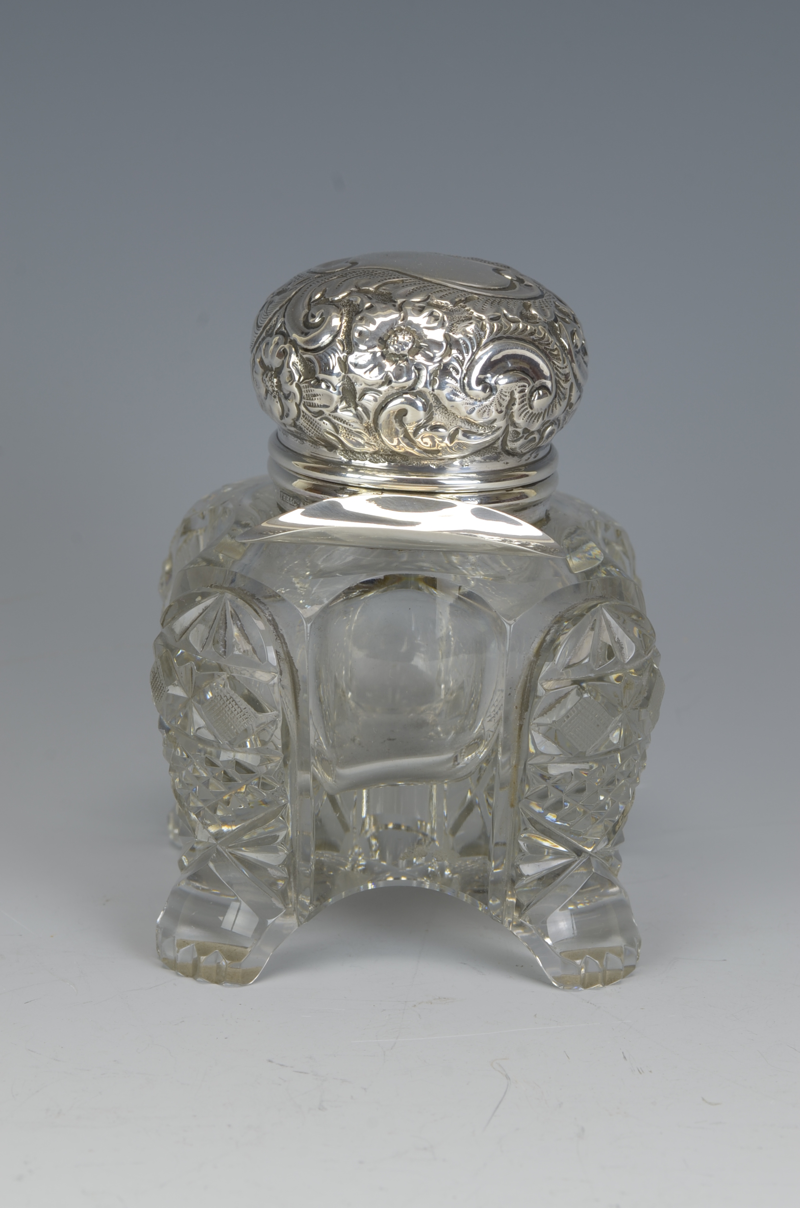 A cut glass Inkwell with floral and scroll embossed hinge lid and pen shelf, mounted upon four paw - Image 2 of 2