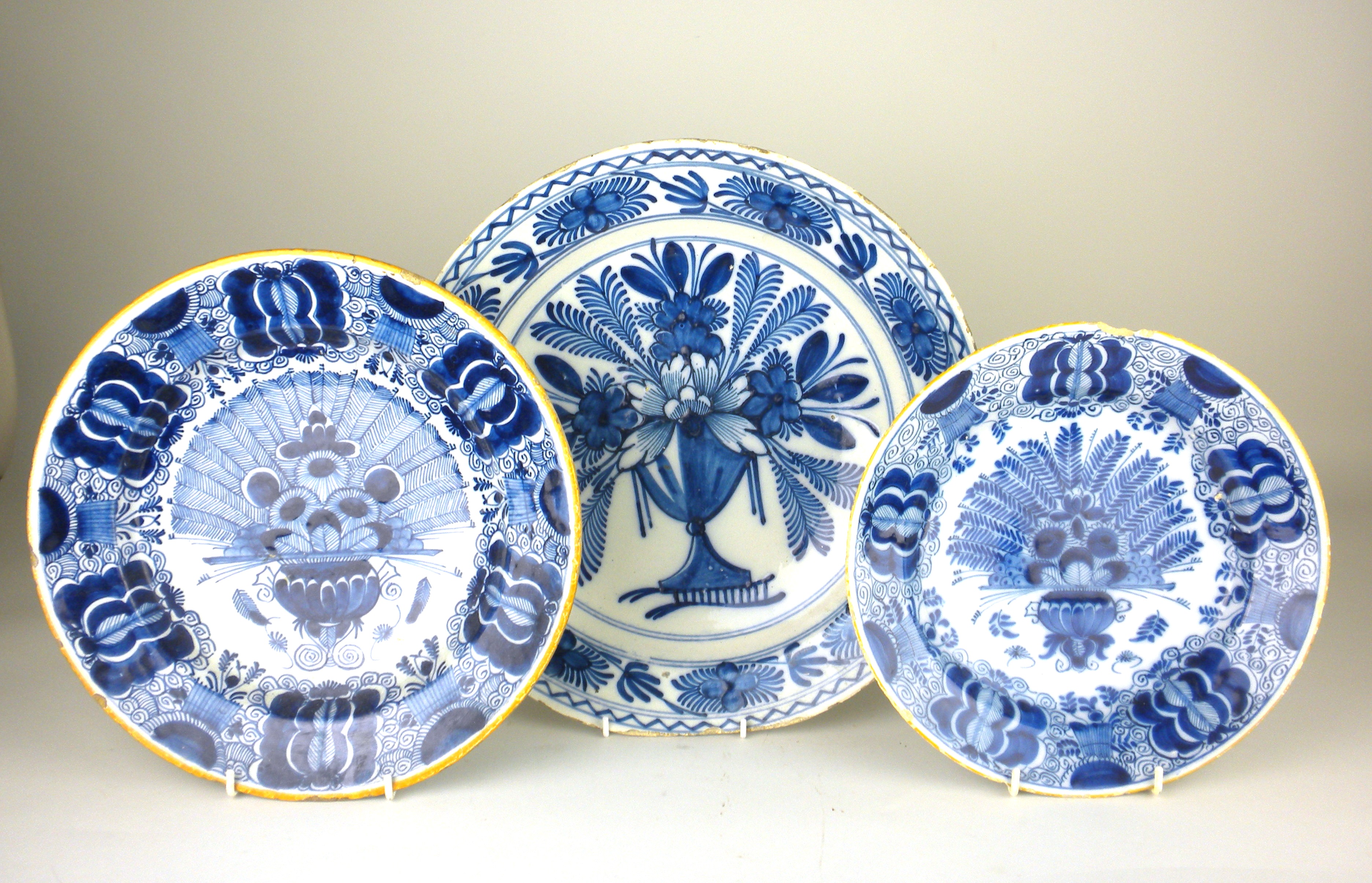 Three Dutch Delft blue and white Dishes, comprising two "Peacock" dishes and another painted with