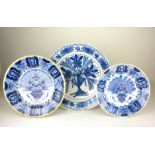 Three Dutch Delft blue and white Dishes, comprising two "Peacock" dishes and another painted with
