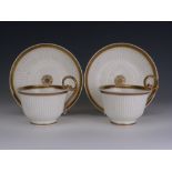 A pair of Swansea porcelain Paris Flute moulded breakfast Teacups and Saucers, circa 1815-1818, with