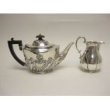 A Victorian silver oval Teapot with gadroon and scroll embossing, London 1898 and a baluster Milk