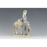 A Lladro Figure with donkey selling wares, 10 1/2in