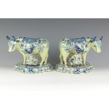 A pair of Dutch delft blue and white Figures of Cows being milked by milkmaid and milkman on