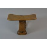 A Carved African Hardwood Head Rest or Pillow with Plaited Leather Carrying Handle.