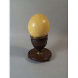 A 19th Century Ostrich Egg on a Wood and Metal Stand.