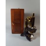 A Lacquered Brass and Black Lacquered Monocular Microscope by J Swift and Son,