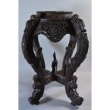 An Intricately Carved Oriental Hardwood Vase Stand with Four Dragon Supports,