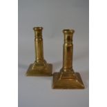 A Pair of Georgian Brass Candlesticks with Turned Barrels and Square Bases. 16.