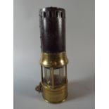 A Richard Johnson Clapham and Morris Miner's Safety Lamp in Brass and Iron,