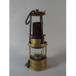 A Brass Miner's Safety Lamp by Richard Johnson Clapham and Morris,