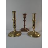 A Collection of Three 19th Century Brass Candlesticks Two With Ejector Slides