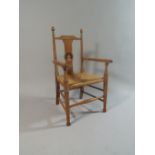 An Edwardian Rush Seated Childs Armchair with Tommy Tucker Decoration to Back Rail