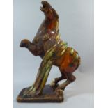 An Antique Chinese Pottery Figure of a Tang Dynasty Style Prancing Horse.