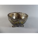 A Heavy Silver Fruit Bowl with Pierced Rim on Four Scrolled Feet. 20cm Diameter, 11cms High.