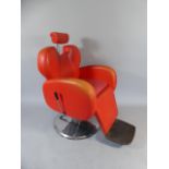 A Vintage American Style Red Leather Barbers Chair with Chrome Base and Adjustable Head Rest.