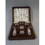 A Cased Silver Cruet Set by Walker and Hall Comprising Pairs of Salts,