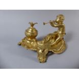 A Gilded Spelter Inkstand with Cherub Playing Trumpet and Inkwell Having Bird Finial to Hinged Lid.