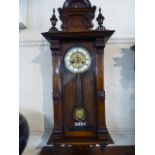 A Late Victorian Vienna Style Mahogany Wall Clock with Painted Supports,