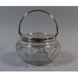 A Silver Topped Cut Glass Biscuit Barrel with Loop Carrying Handle by James Dixon and Sons.