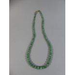 A String of Graduated Jadeite Beads.