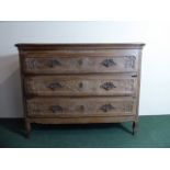 An 18th Century French Oak Commode Chest with a Three Plank Top Over Three Drawers with Carved