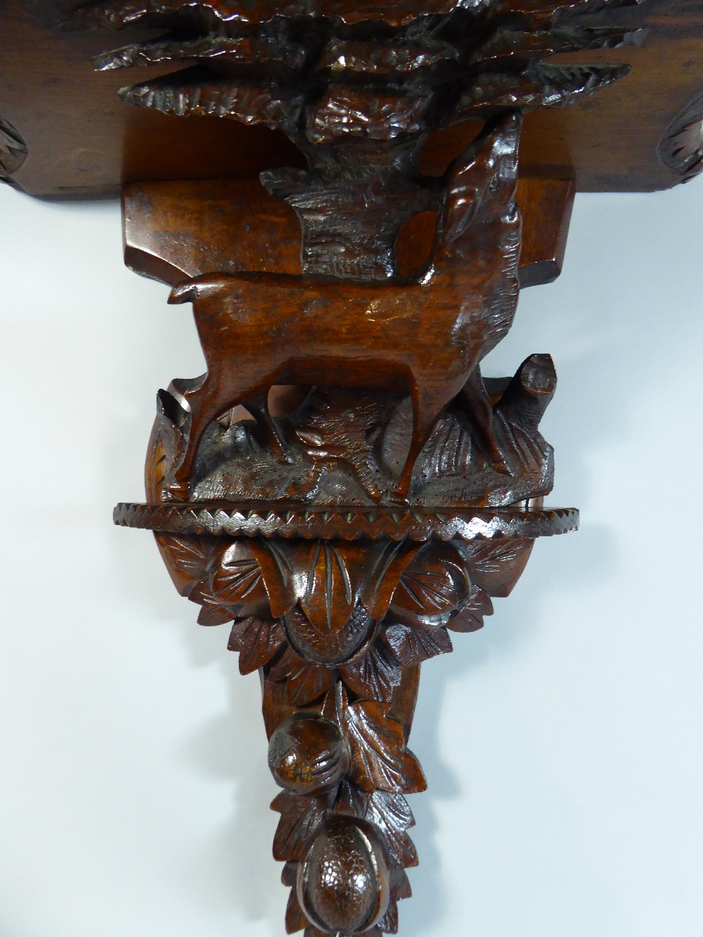A Black Forest Wall Shelf with Carved Decoration depicting Walnuts and Female Red Deer Beside Tree. - Image 2 of 3