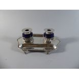 An Edwardian Silver Two Bottle Ink Stand with Pierced Supports for Two Blue Glass Ink Wells with