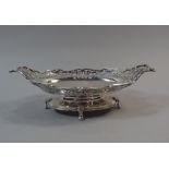 A Good Silver Two Handled Oval Bowl with Pierced Sides, Oval Plinth and Four Scrolled Feet. 24.
