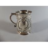 A Georgian Silver Tankard with Embossed and Engraved Foliate Decoration.