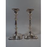 A Pair of Silver Candlesticks 23.