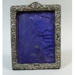 A Late Victorian/Edwardian Silver Repousse Work Photo Frame Decorated with Scrolling Floriate