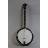 A Vintage Four String Mastertone Banjo. Gibson Branding in Mother of Pearl.