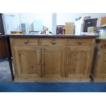 A Contemporary Granite Topped Pine Kitchen Base Unit with Three Drawers over Cupboards.