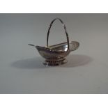 An Oval Silver Sugar Basket with Pierced Rim and Loop Carrying Handle. 16cm Long. 149gms.