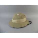 A Canvas Covered Tropical Pith Helmet,