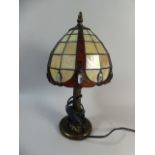 A Reproduction Tiffany Style Table Lamp with Jewelled Shade and Tree Trunk Support,