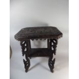 A Ornately Carved Indian Occasional Table Decorated with Elephant on Carved Pierced Supports,