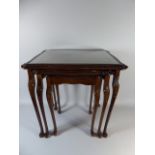 A Nest of Mahogany Tables with Tooled Leather Tops