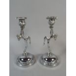 A Pair of Art Deco Chromed Candle Sticks, the Supports in the form of Nude Girls with Leg Raised,